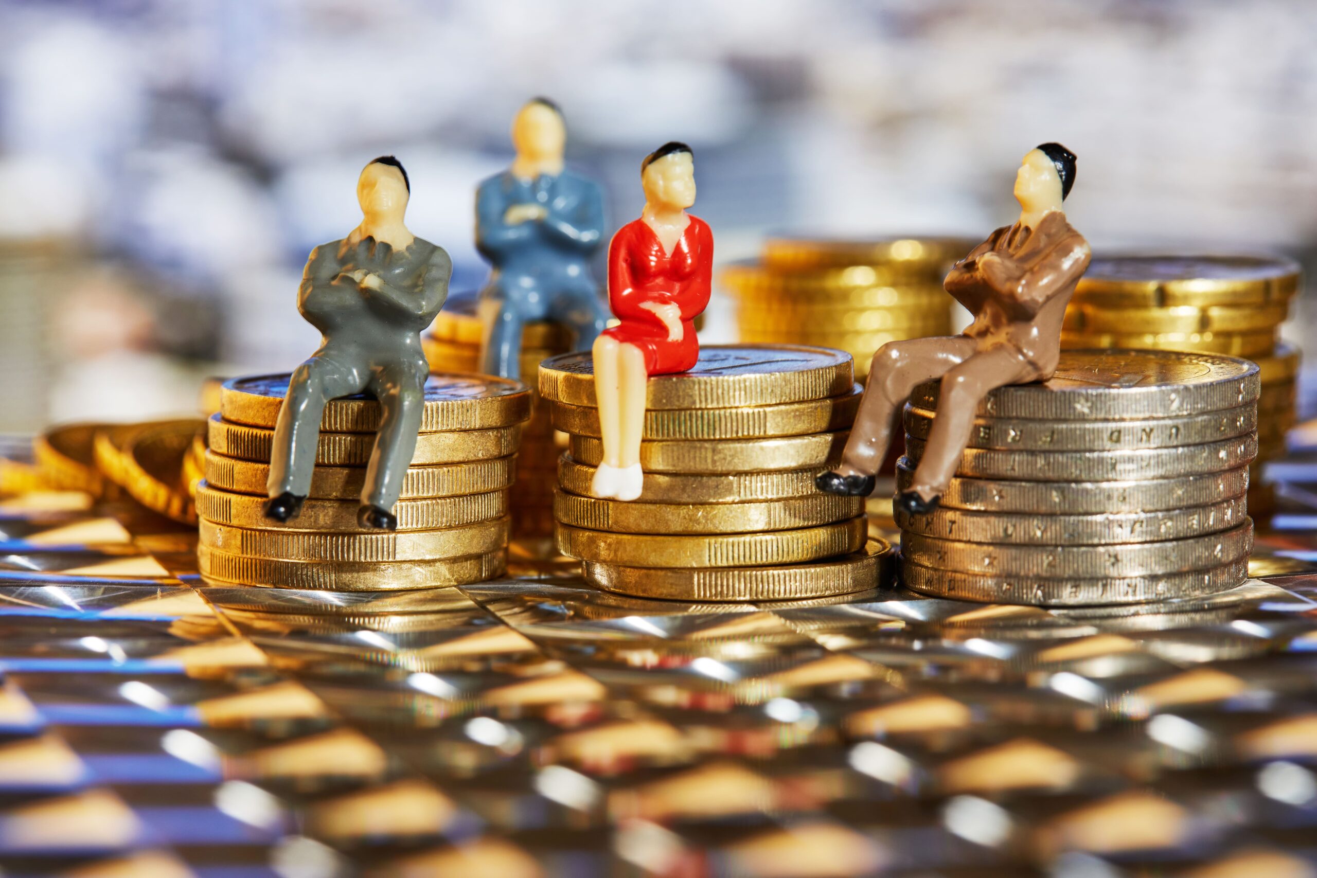 Miniature business figures sitting on stacks of coins, symbolizing B2B content turning activity into revenue.