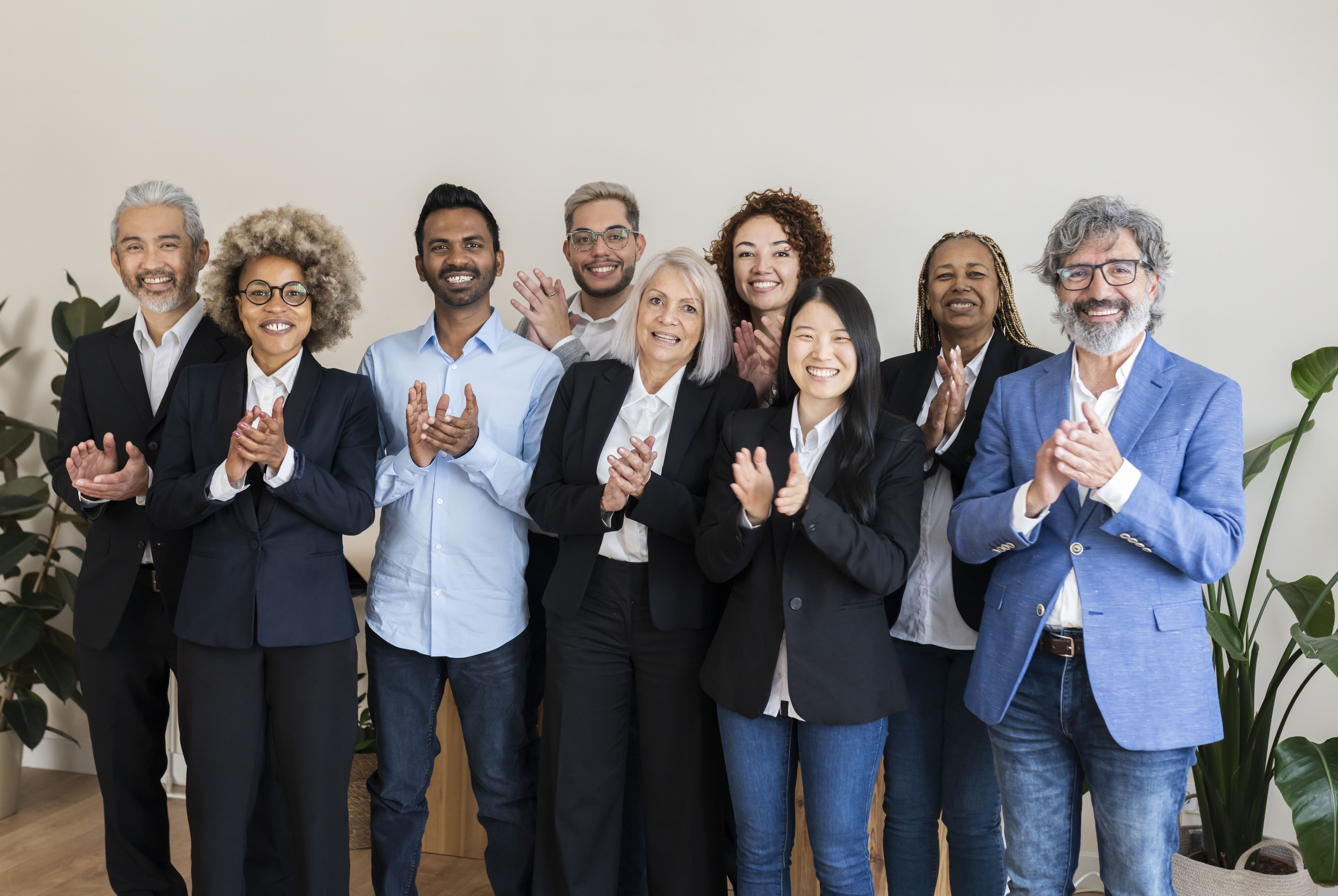 Business team standing together, symbolizing collaboration among multiple stakeholders.