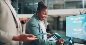 Professional woman reviewing information on a tablet, symbolizing visibility and communication challenges in the fintech sector.