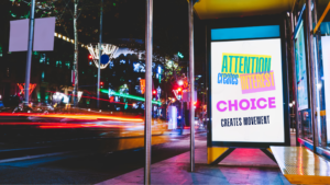 Digital billboard in a city street highlighting how brands compete for attention in crowded environments