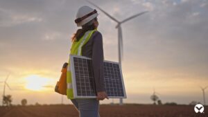 CleanTech brand film thumbnail showing a worker holding a solar panel with wind turbines in the background.