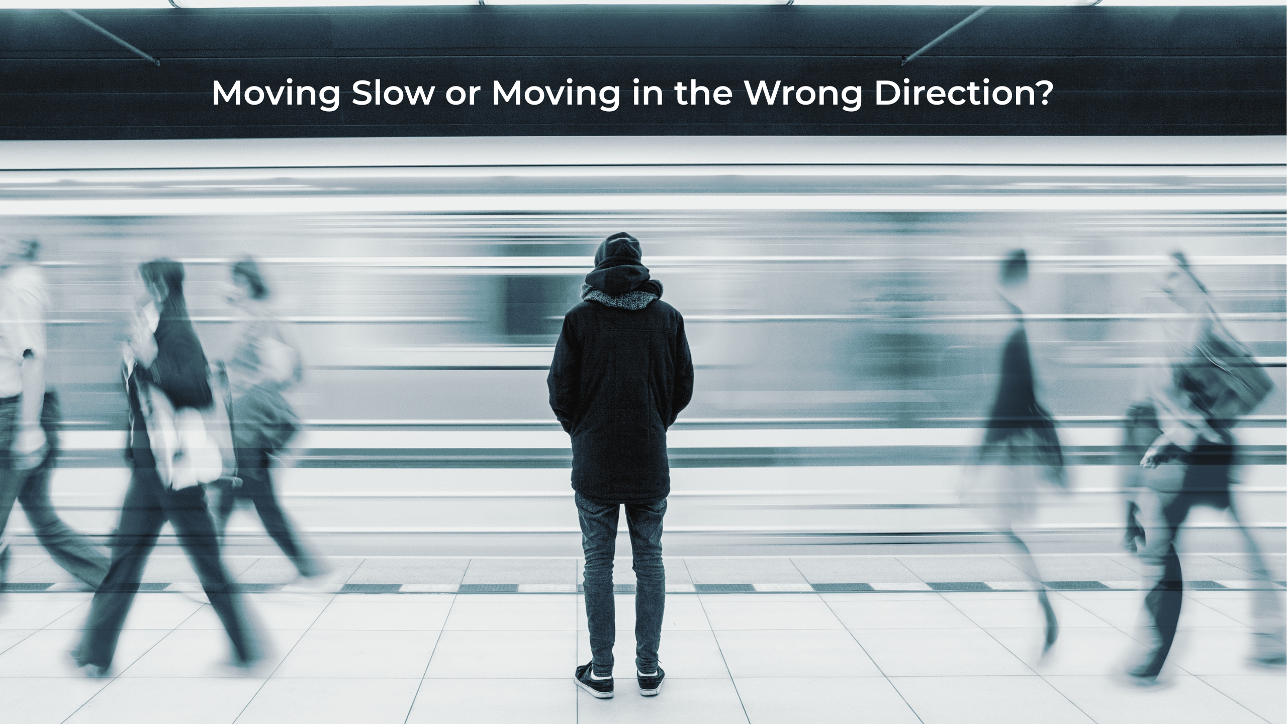 Person standing still on a subway platform while commuters blur past, symbolizing slow movement versus moving in the wrong direction in business strategy.