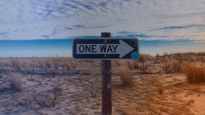 One-way sign in a natural landscape representing a clear, aligned marketing system that drives direction and impact