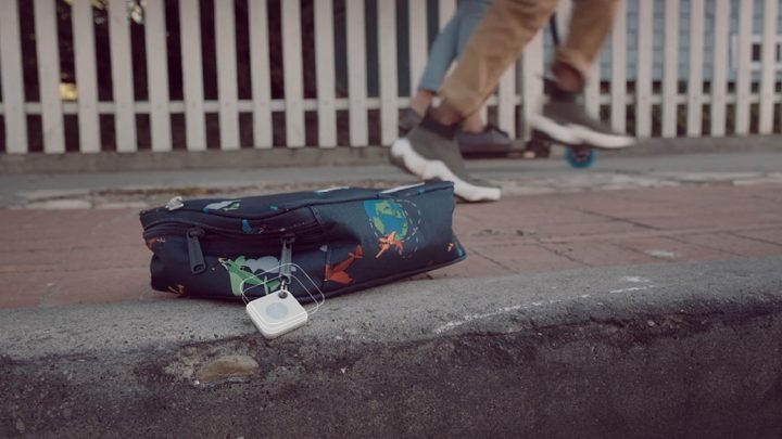 Tile ad scene: a child's bag left on a curb with a Tile tracker attached