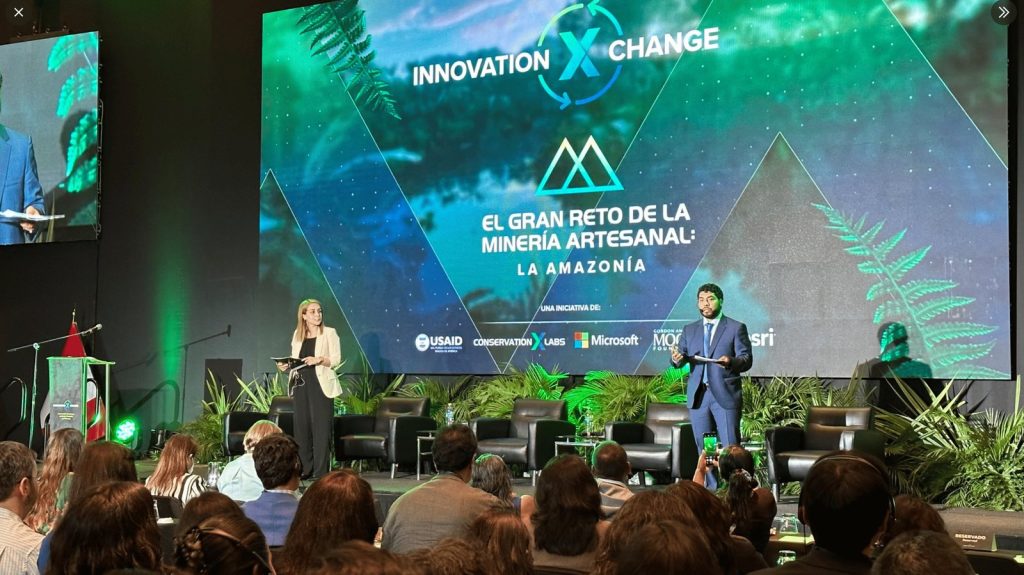 Innovation X Change stage in Lima with the event branding and the Artisanal Mining Grand Challenge on screen