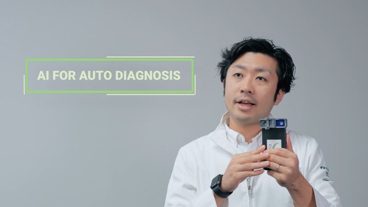 Presenter holding the Smart Eye Camera phone attachment beside the caption AI for auto diagnosis, from the World Bank film by Room4 Media