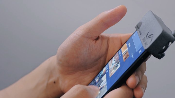 Hand using a smartphone fitted with the eye camera attachment