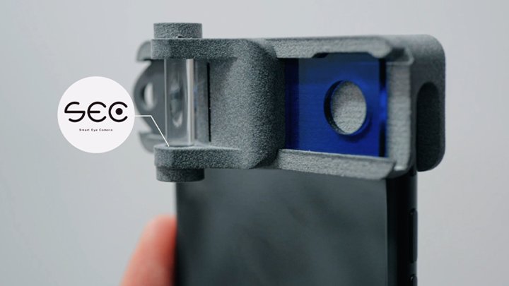 Close-up of the Smart Eye Camera attachment on a smartphone, labelled SEC